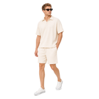 Model walking – WEELZ off-white textured V-collar shorts set