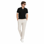 WEELZ Geometric-Collar Zip Knit Polo in Black & Cream — styled with stone trousers