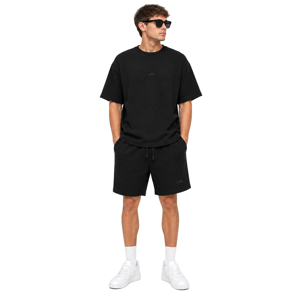 WEELZ black textured cotton T-shirt and shorts set worn by model — look 1